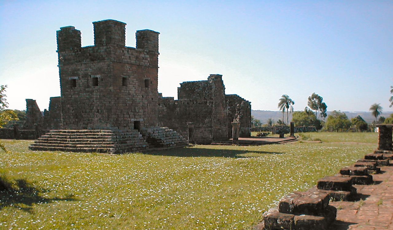 Ancient stone ruins stand quietly on a grassy field
