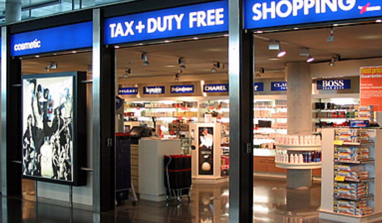 A duty-free shopping area at an airport with luxury brand displays.