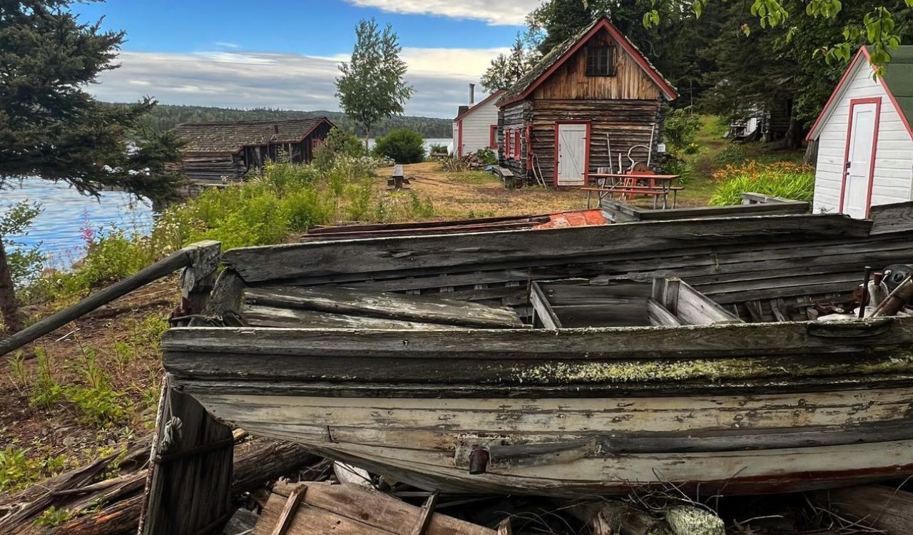 Old wooden boat and rustic cabins on a lakeside in Isle Royale National Park