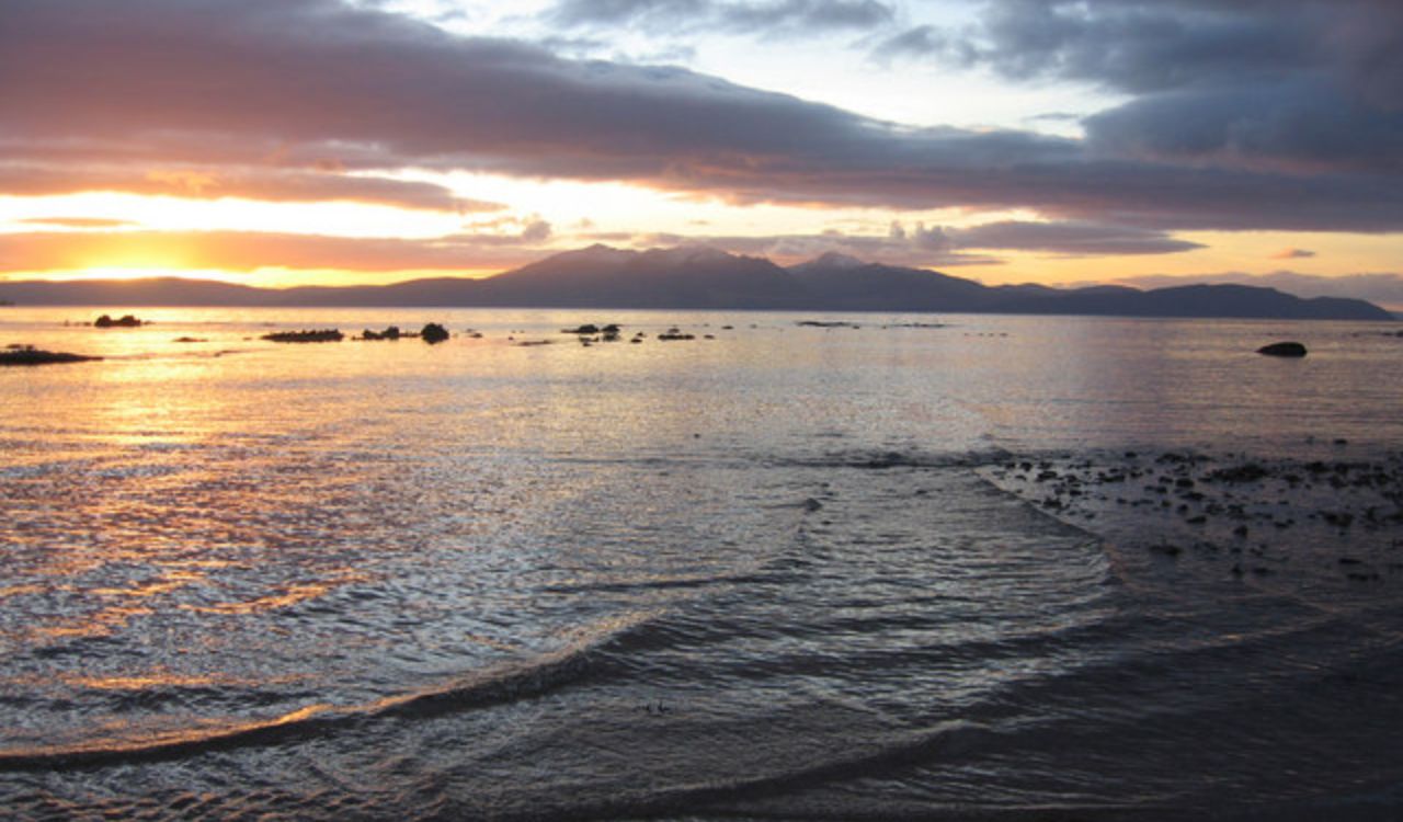 Sunset over the water with the Isle of Arran in the distance
