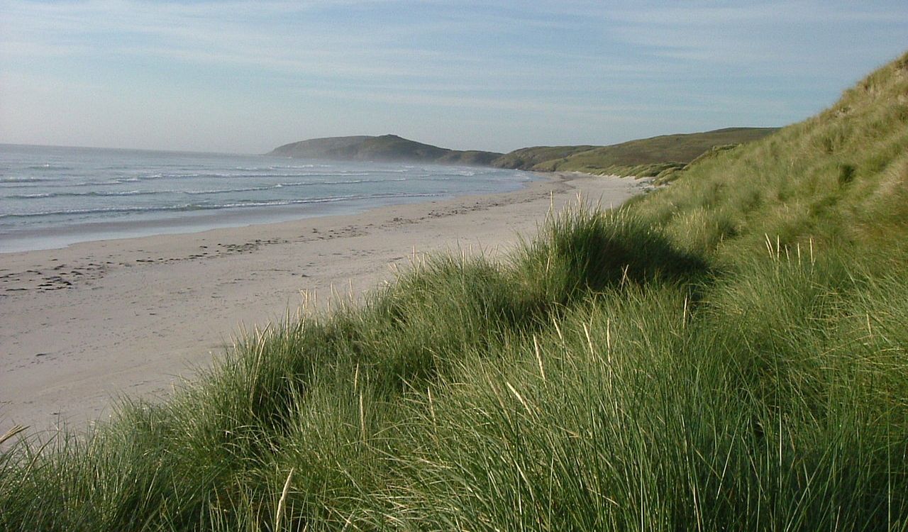 Grassy dunes and quiet beach on the Isle of Barra