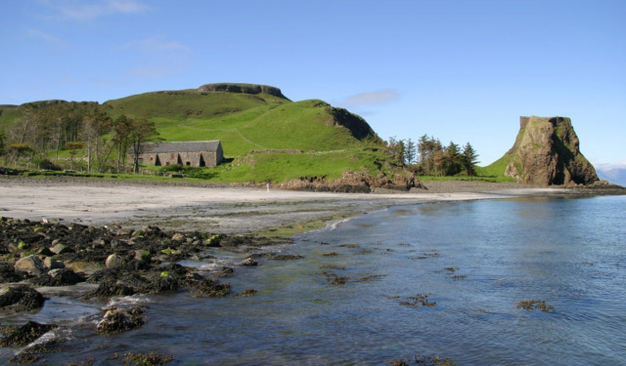 Rocky shore and green hills on the Isle of Canna