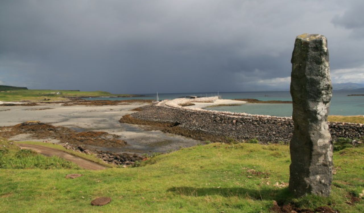 Stone pillar overlooks rocky shore on the Isle of Eigg