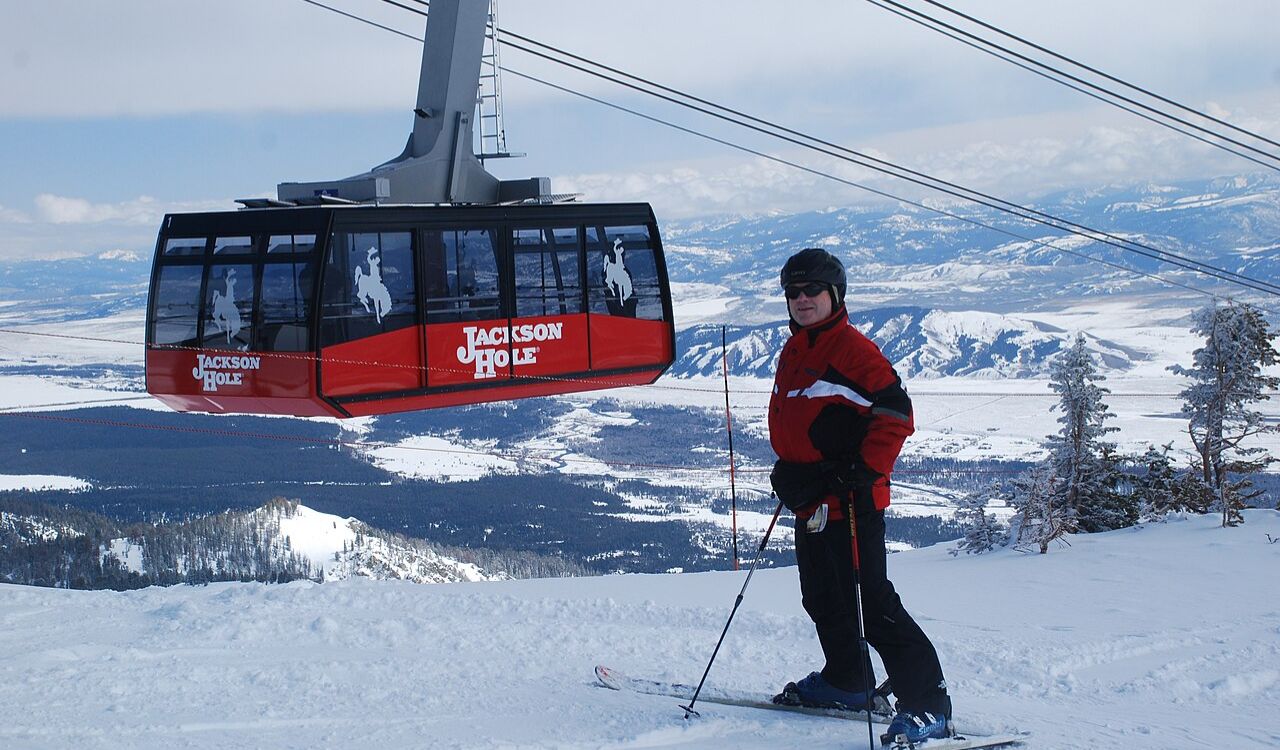 Skier at Jackson Hole Mountain Resort with scenic snowy landscape and aerial tram