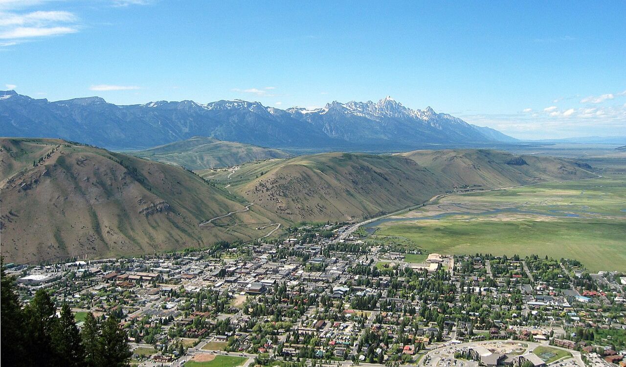 Jackson Hole, Wyoming, with the Teton Range in the background and a quaint town in the valley