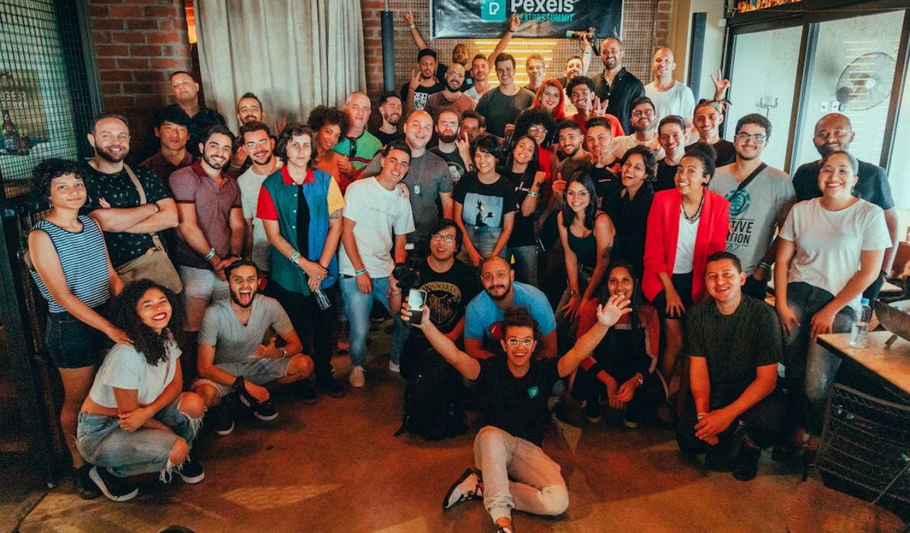 Large diverse group of people smiling at a local meetup event