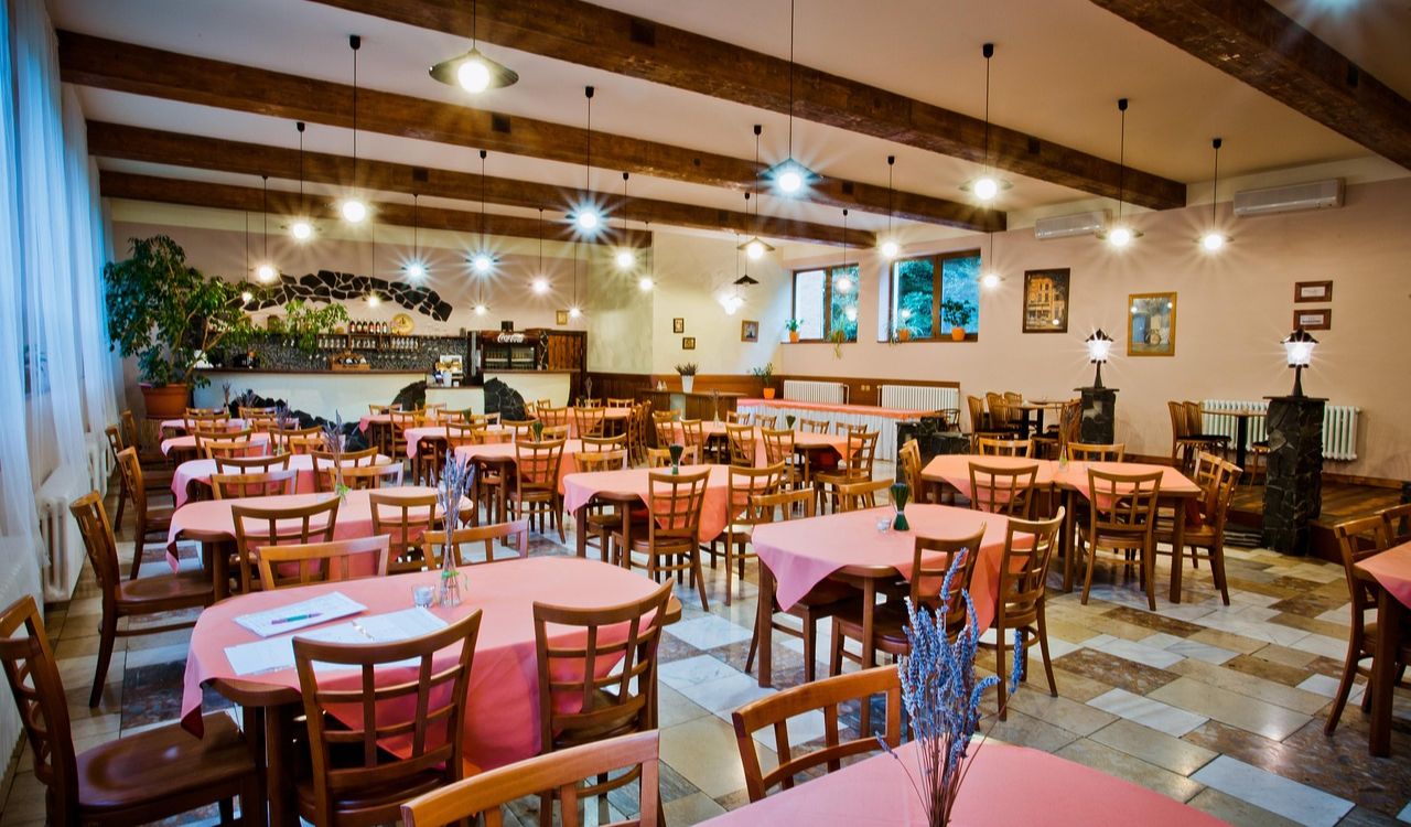 Hotel restaurant with pink tablecloths and wooden chairs