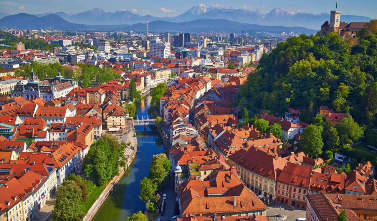 Aerial view of Ljubljana, Slovenia with red rooftops, castle, and river