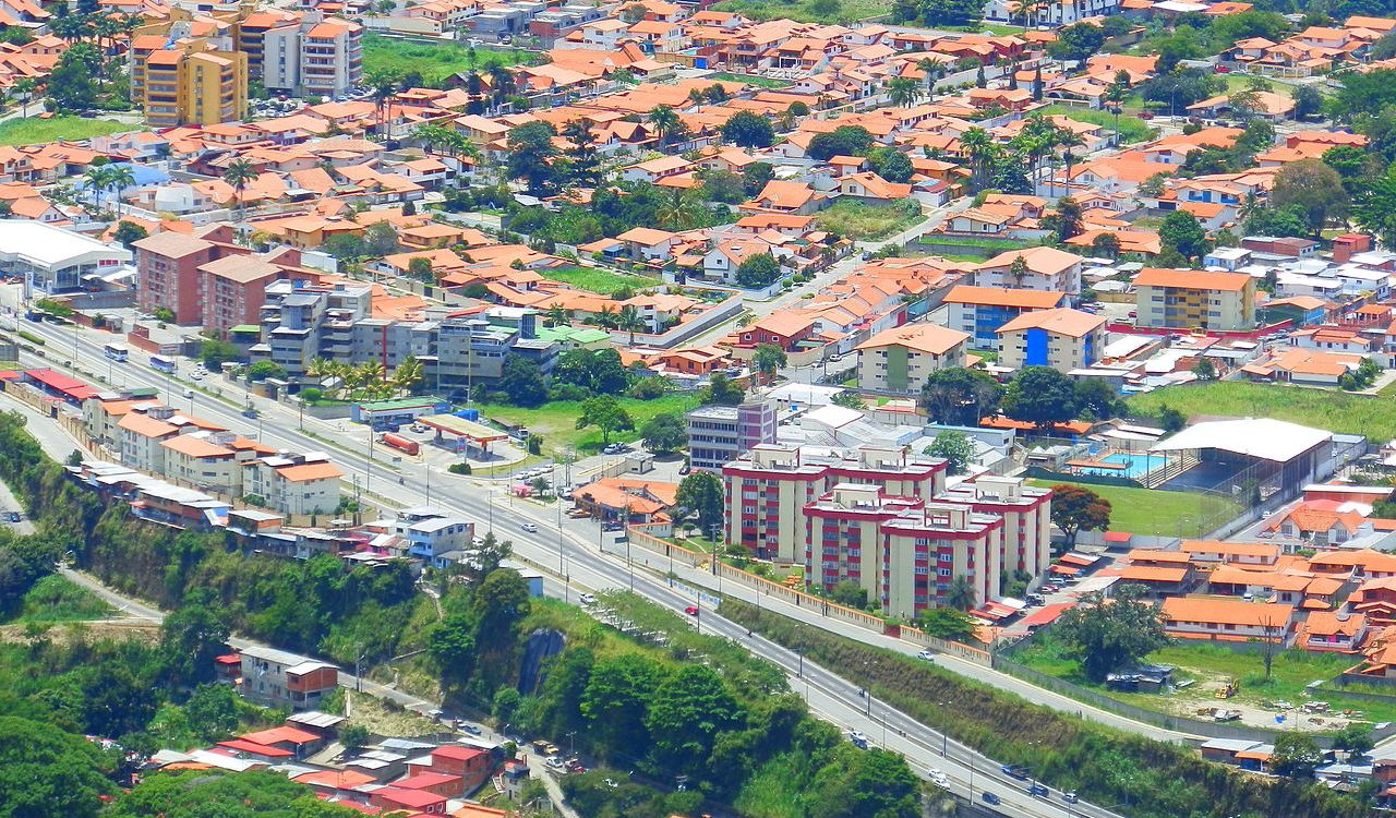Colorful red-roofed homes and mountain views define Mérida’s peaceful hillside charm