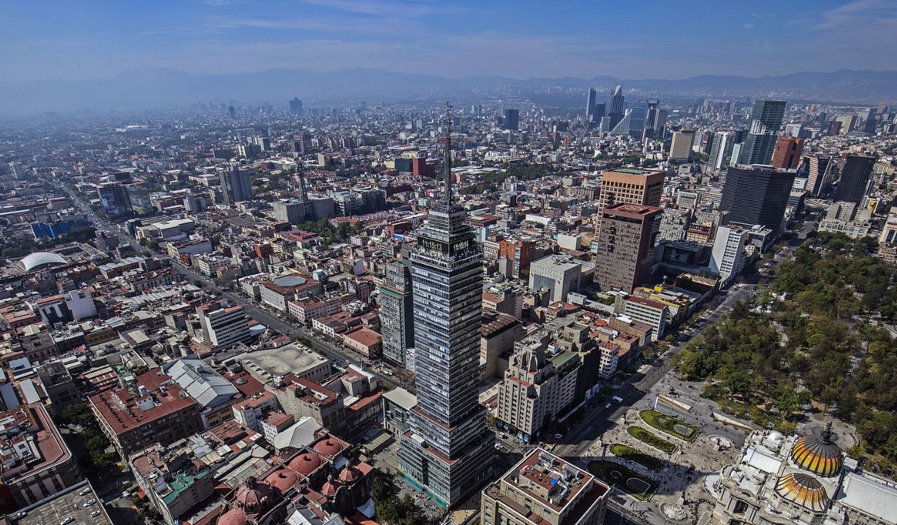 Aerial view of Mexico City with Torre Latinoamericana rising among dense urban buildings