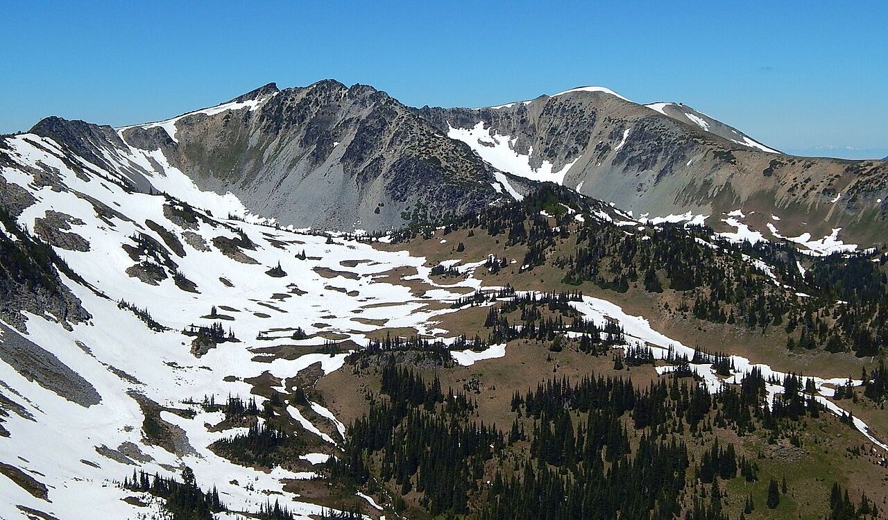 Snow-dotted alpine ridge and rugged peaks in Mount Rainier National Park, Washington