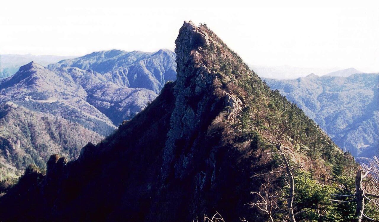 Sharp peak of Mount Ishizuchi, the highest mountain in western Japan, surrounded by rugged terrain