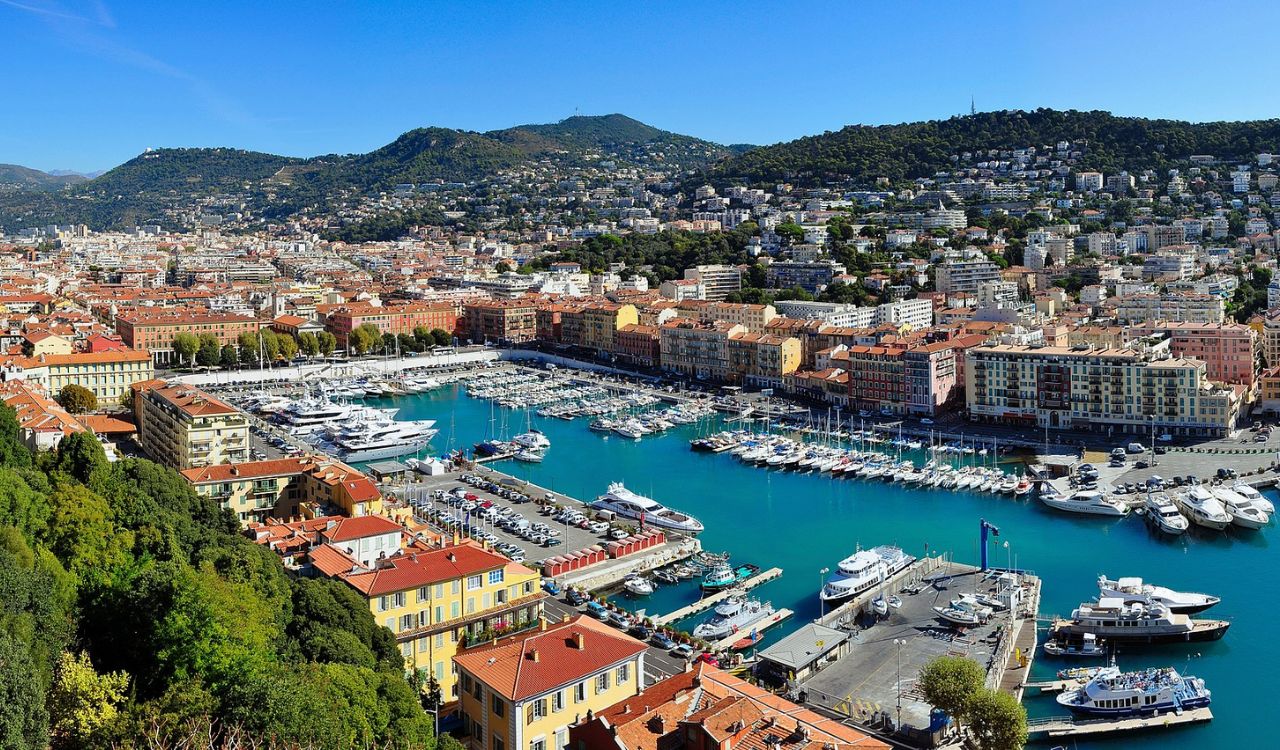 Colorful harbor view of Nice, France with yachts and coastal buildings