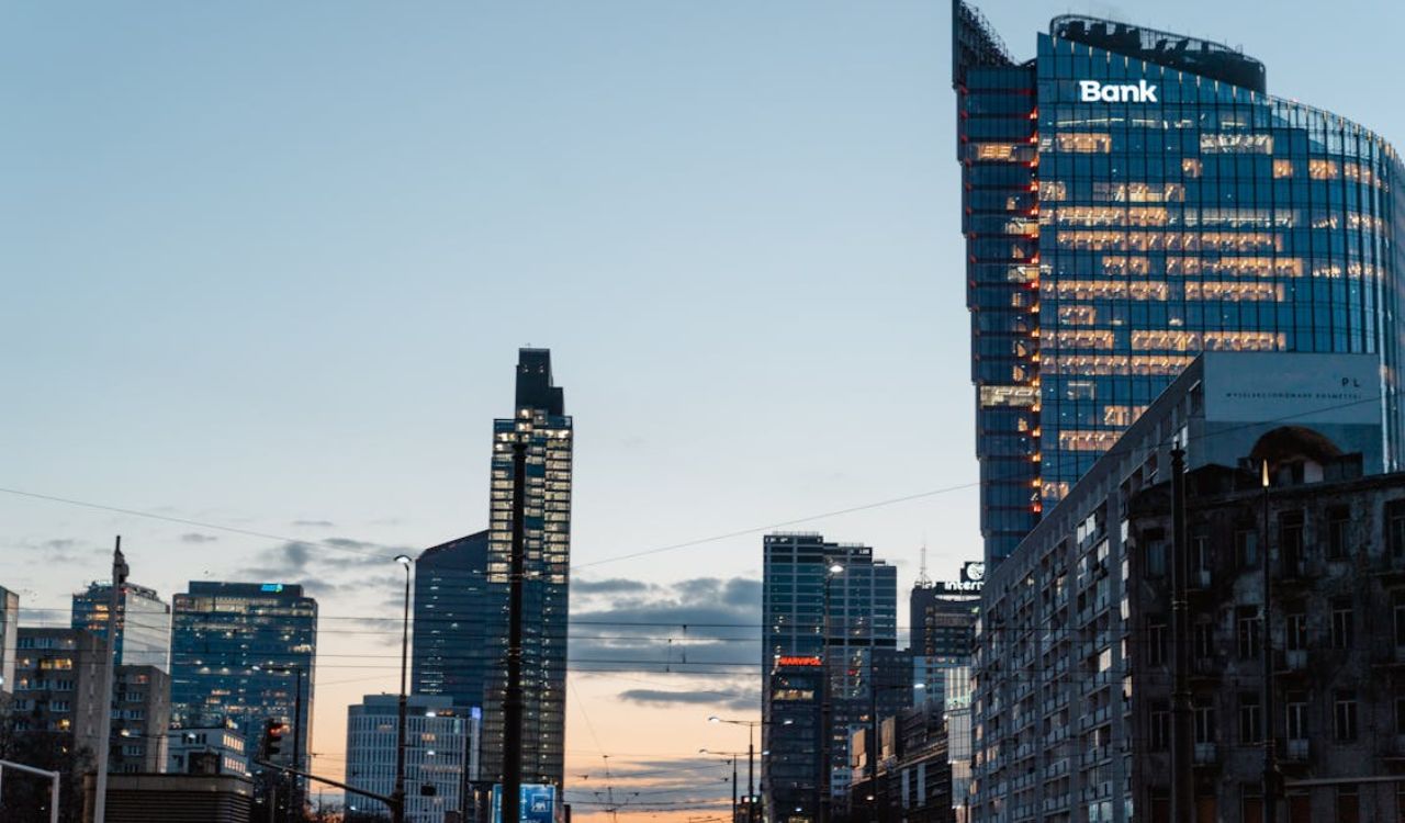 Modern city skyline with tall glass buildings at dusk