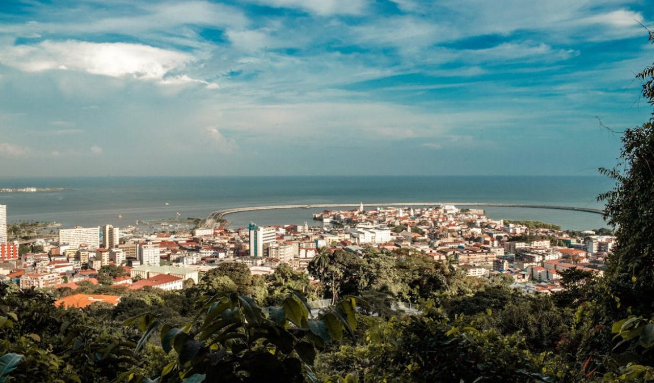 A coastal cityscape in Panama, where lush greenery meets the Pacific horizon