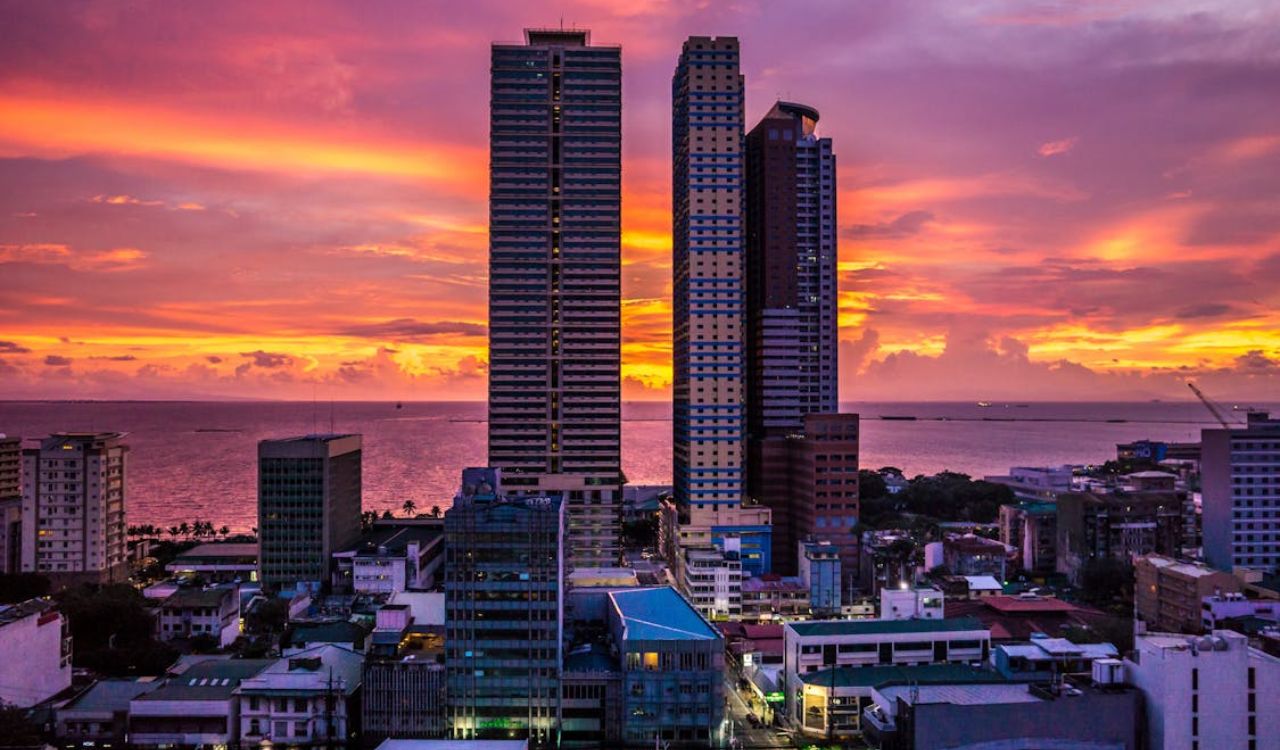 A dramatic Manila Bay sunset bathes the Philippine skyline in vibrant hues