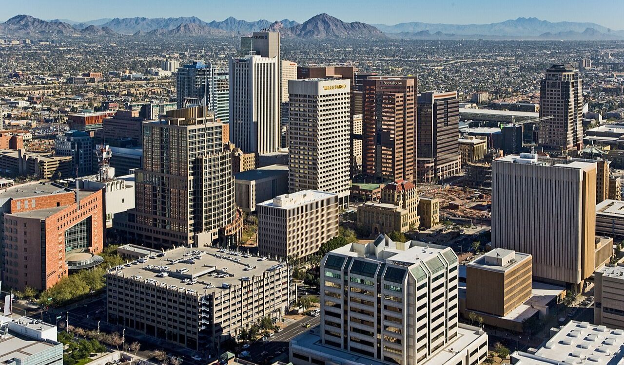 Phoenix rises boldly amid a desert basin, framed by rugged peaks