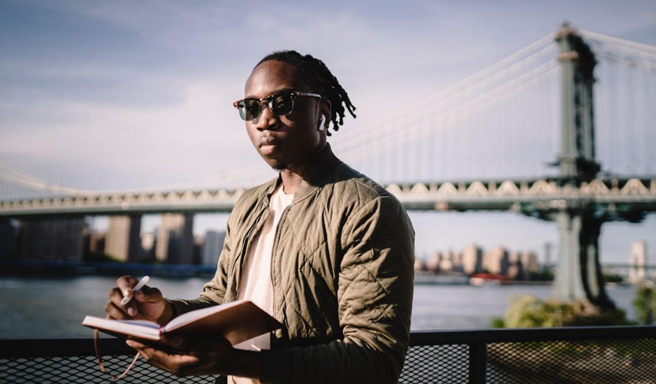 Man planning a trip by the bridge, ready to save big on travel