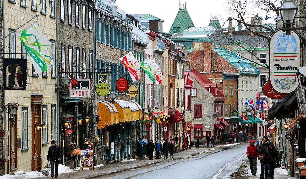 Charming winter street in Old Quebec City, Canada with historic buildings and shops