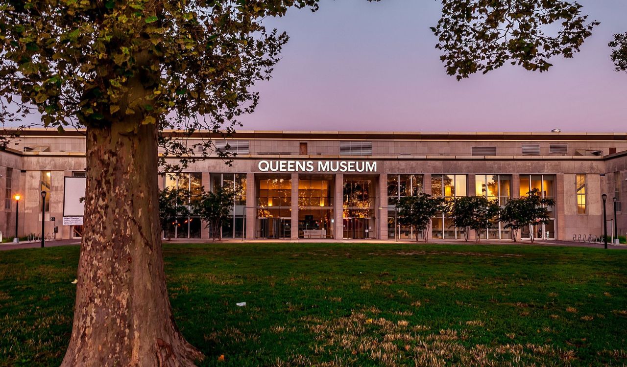 Queens Museum at sunset with trees