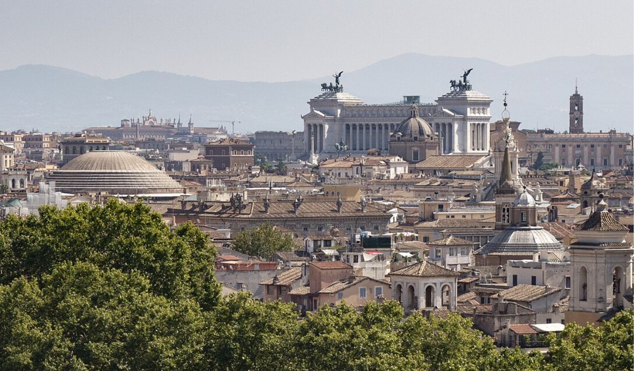 Panoramic skyline of Rome featuring the Pantheon dome and Vittoriano monument
