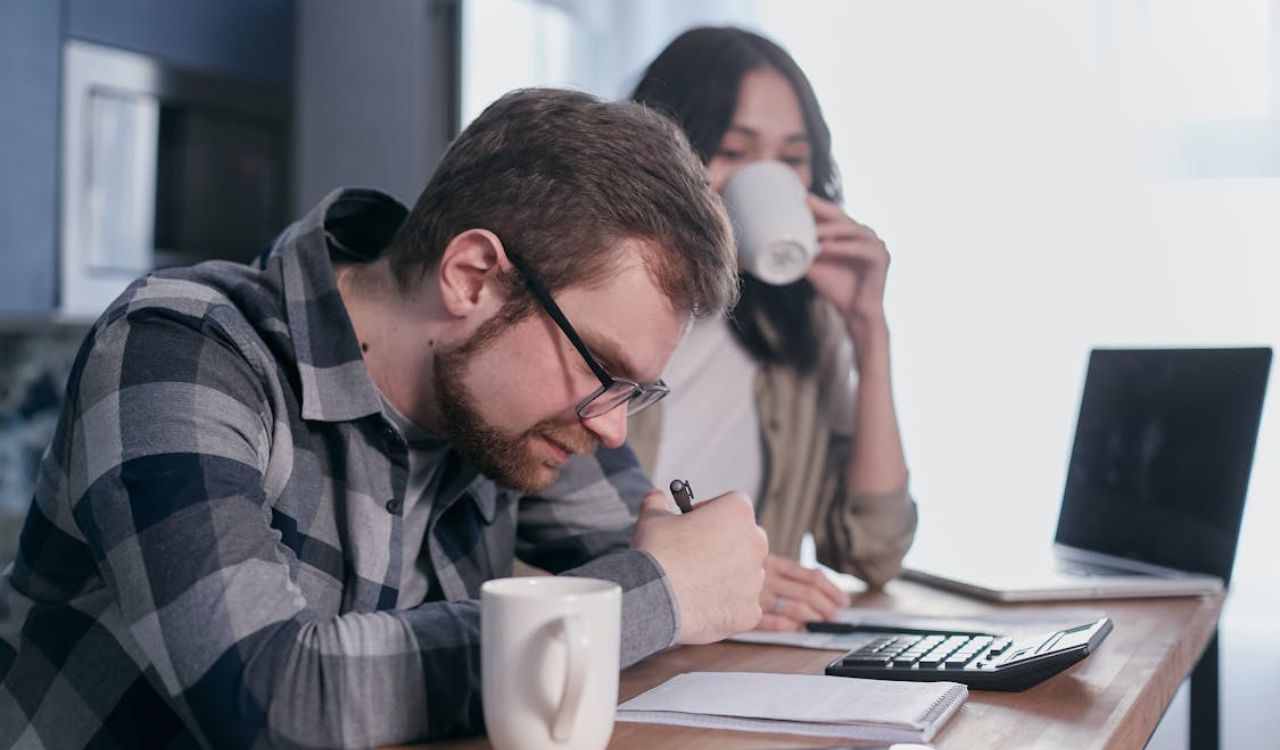 Focused planning over coffee — setting a daily travel budget keeps spending on track