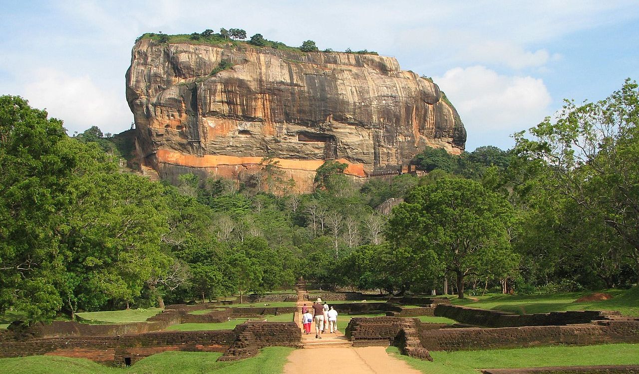 Sigiriya Rock Fortress in Sri Lanka surrounded by lush greenery and ruins