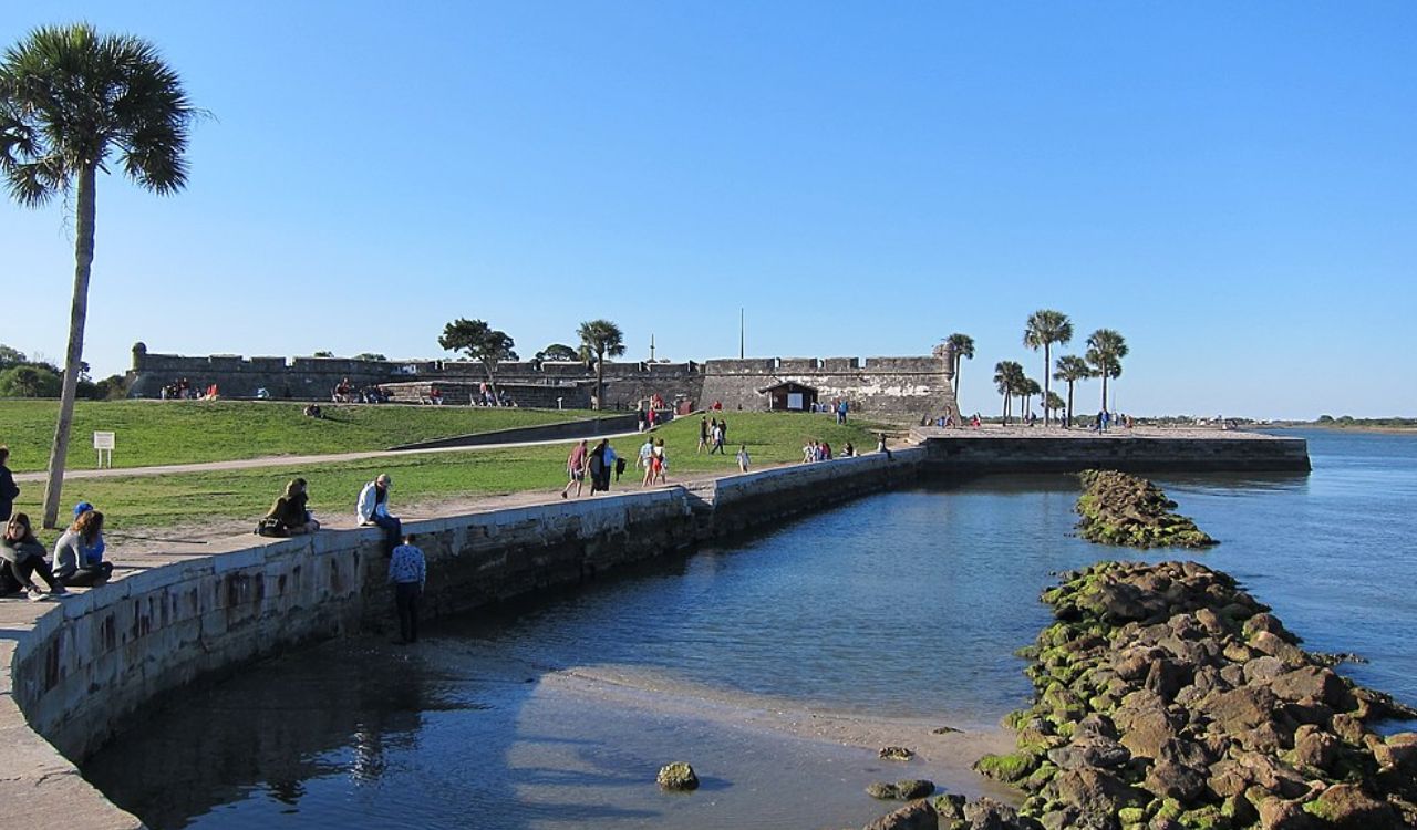 St. Augustine, Florida, with a fort, pathway, and people by the water.









