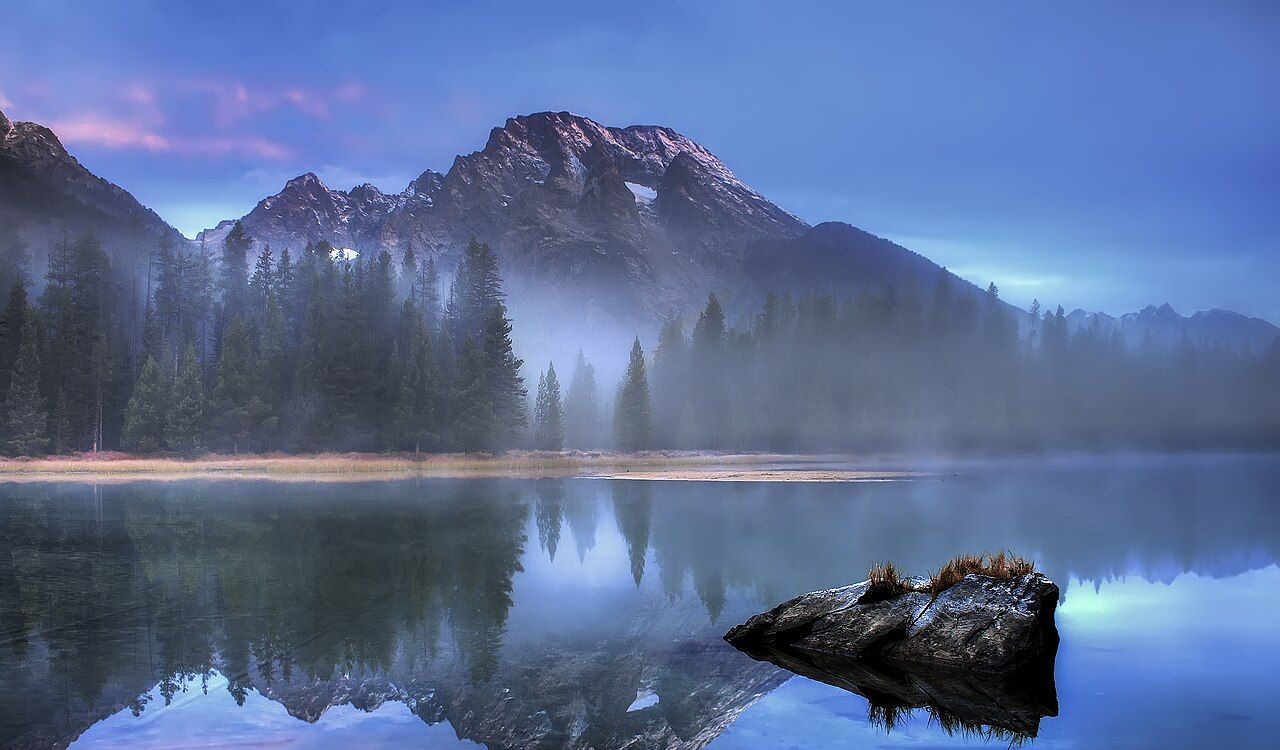 Misty lake with mountain reflection in Grand Teton National Park