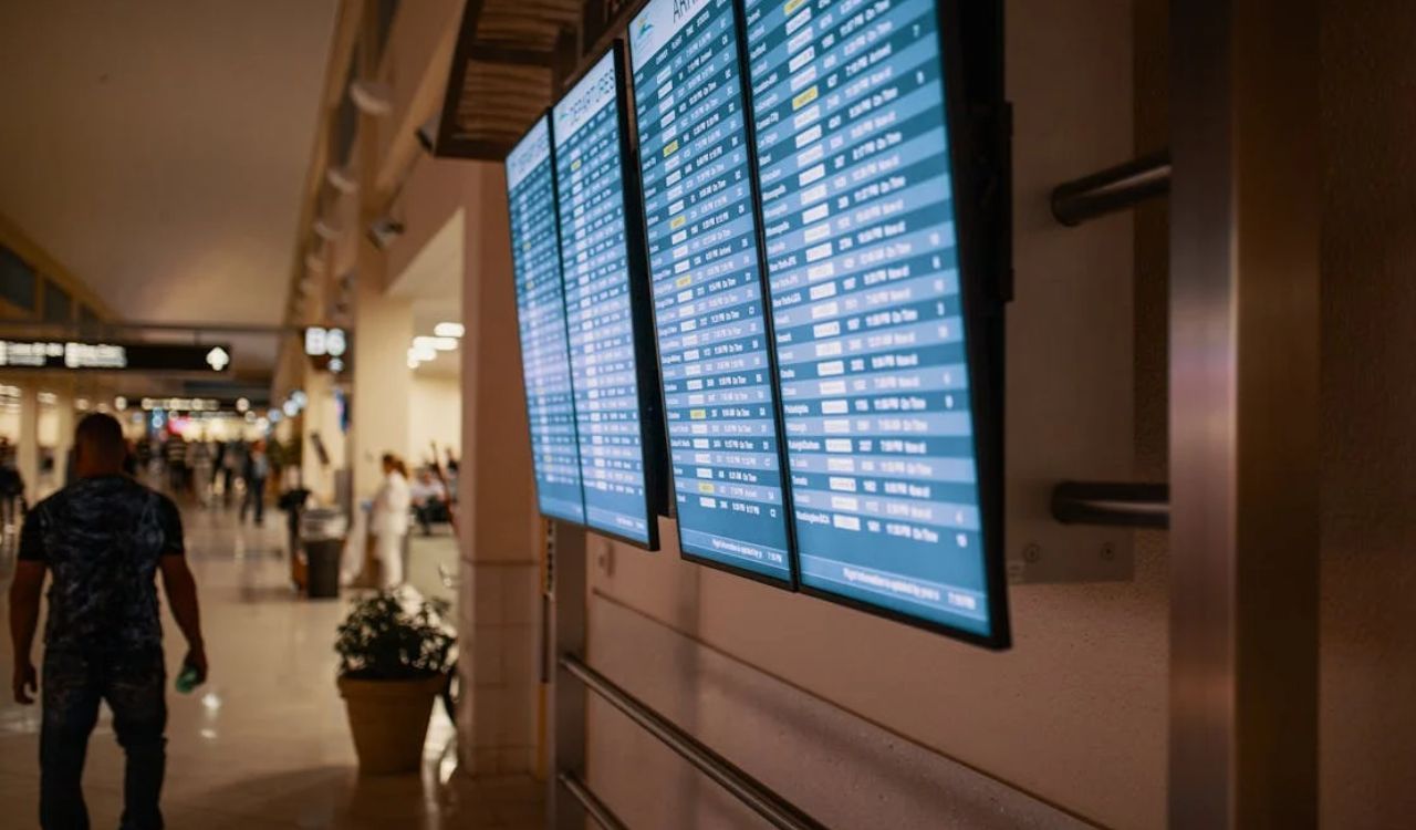 Digital flight information screens in a busy airport terminal