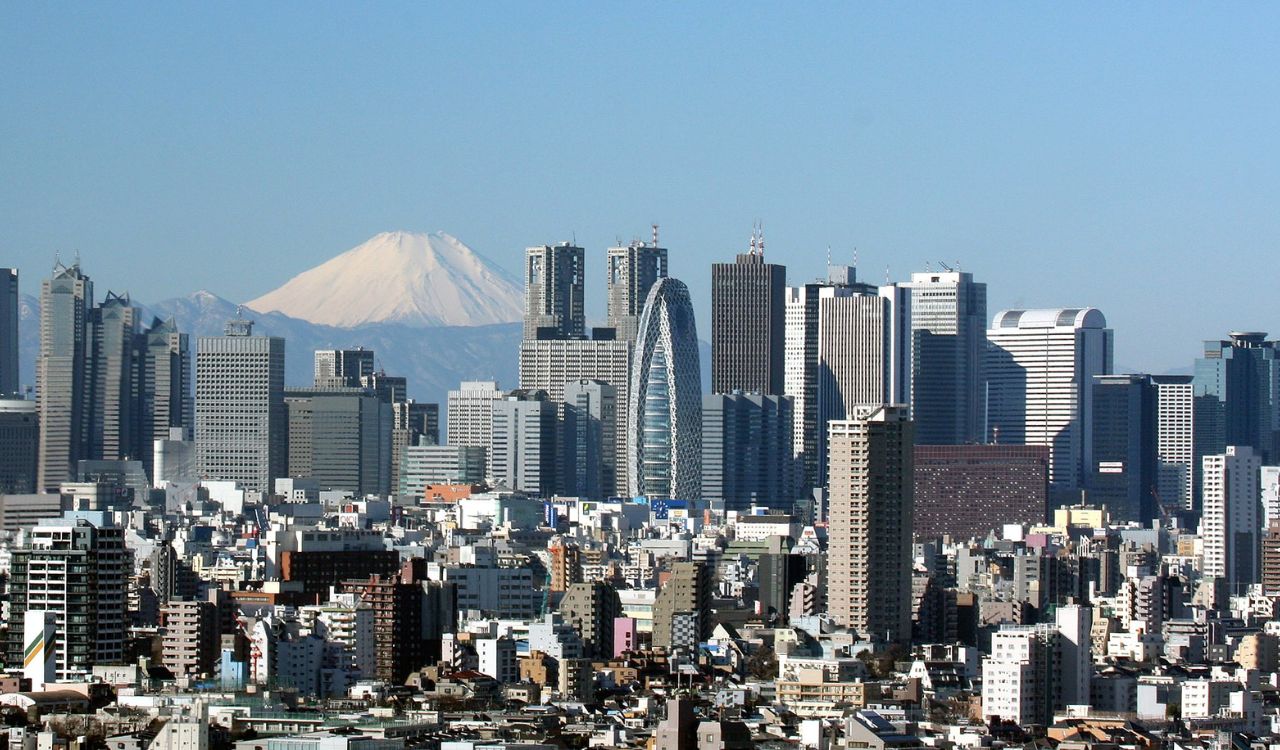 A panoramic view of Tokyo’s skyline with Mount Fuji in the background, showcasing a blend of modern skyscrapers and traditional cityscapes