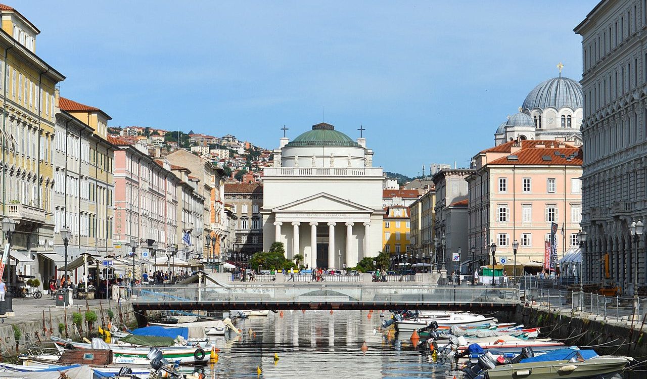 Canal view of Trieste, Italy with neoclassical church and boats