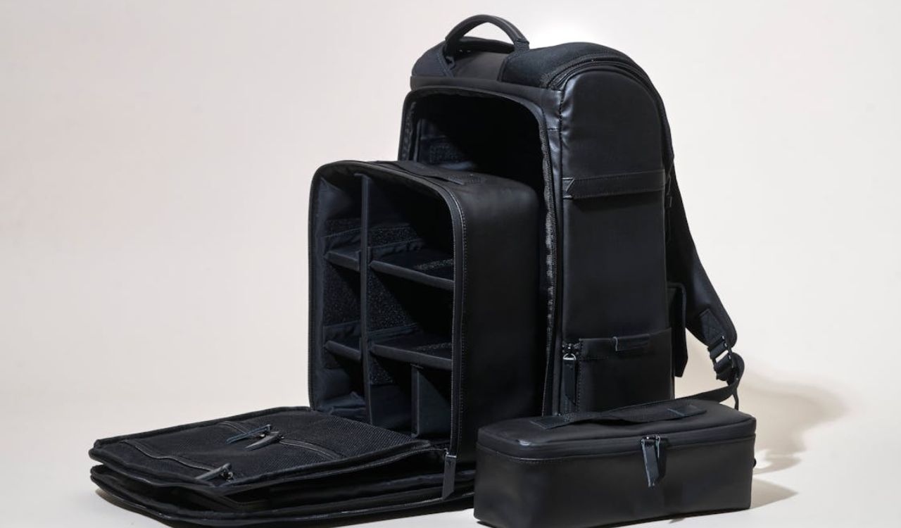 Black travel backpack with open compartments and organizers