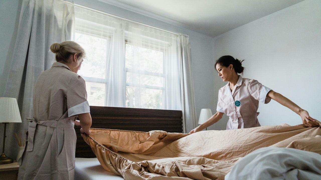 MSNPS- Women Putting Bed Sheet in a Bed