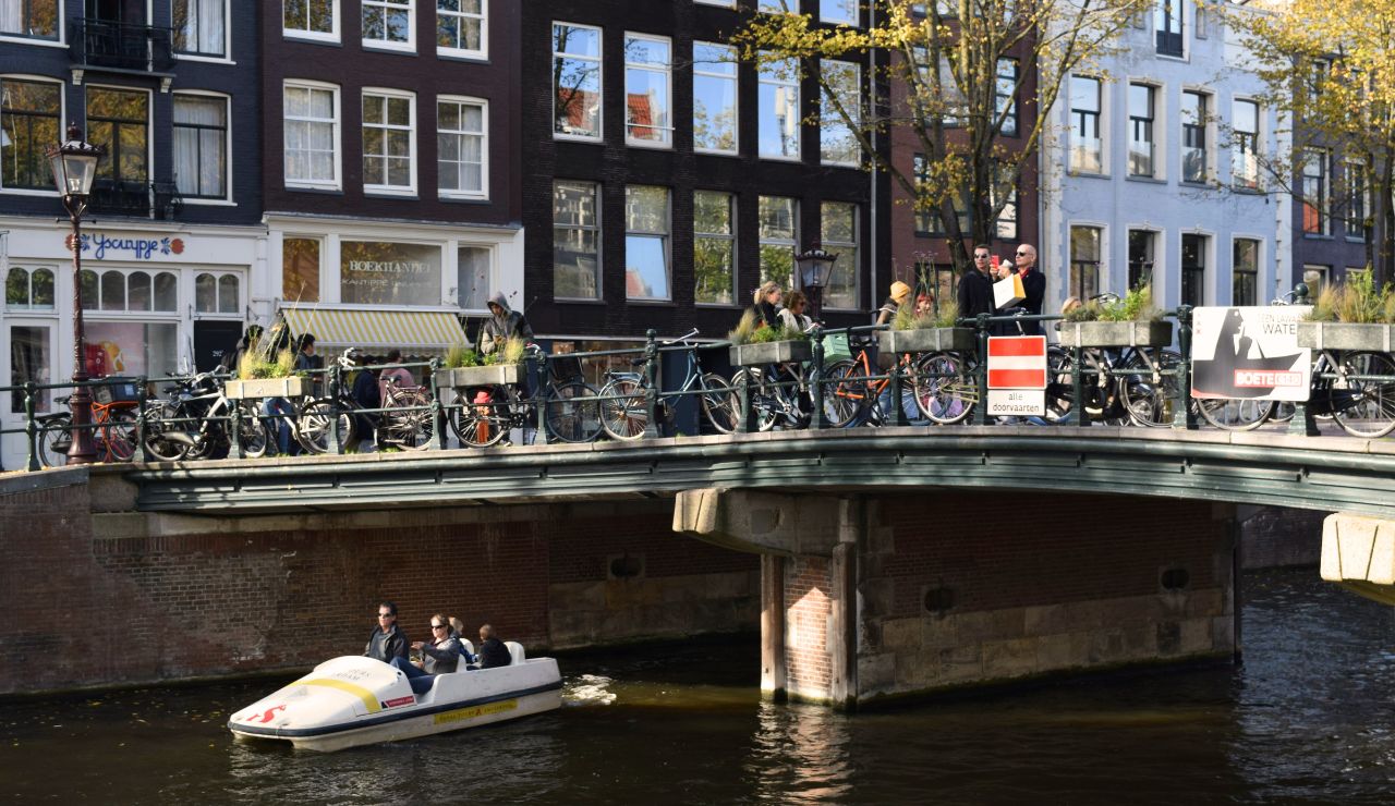 Amsterdam canal with Bicycles and blooming tulips in spring