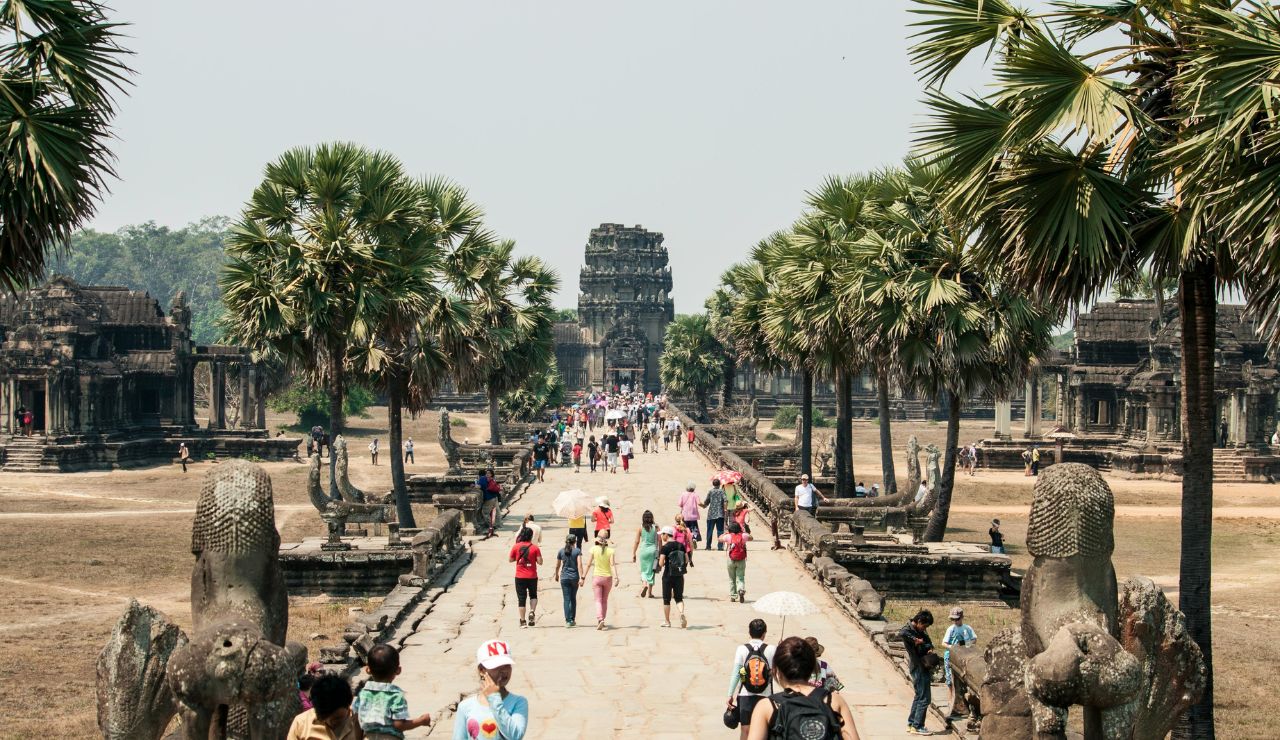 Tourists walking through Angkor Wat temple complex