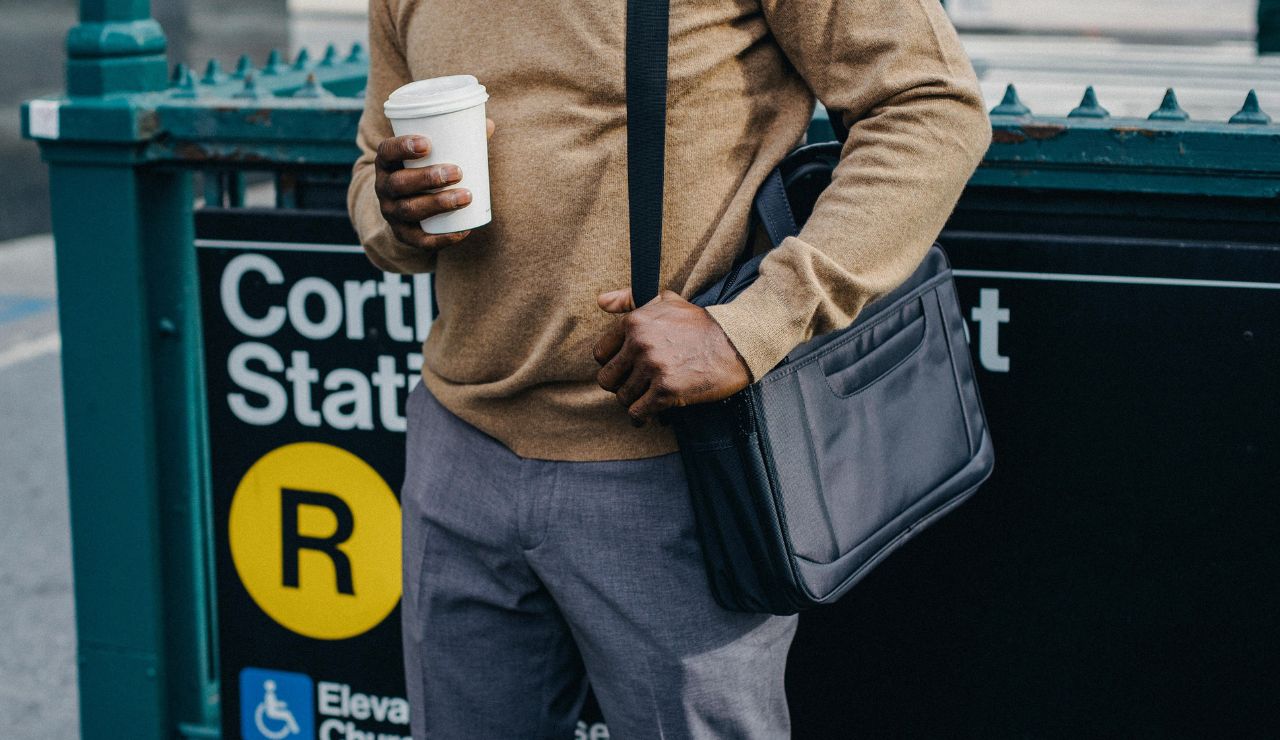 Anti-theft crossbody bag worn in a crowded area.
