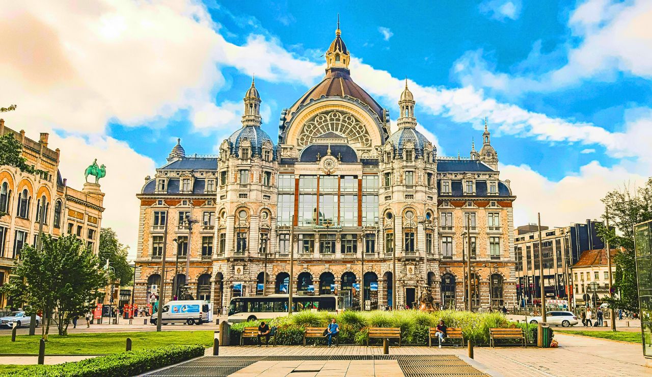 The ornate facade and glass dome of Antwerp Central Station in Belgium.