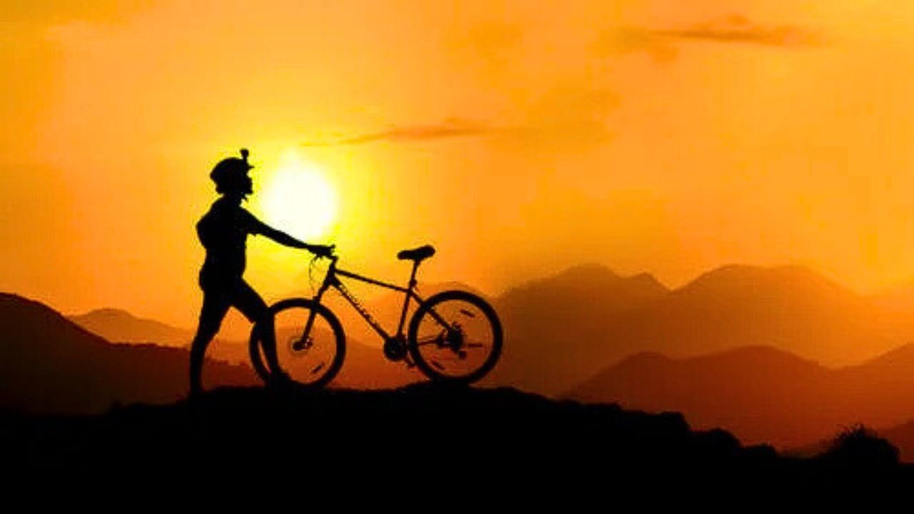 Wide landscape of Aquarius Plateau with biker silhouette on trail