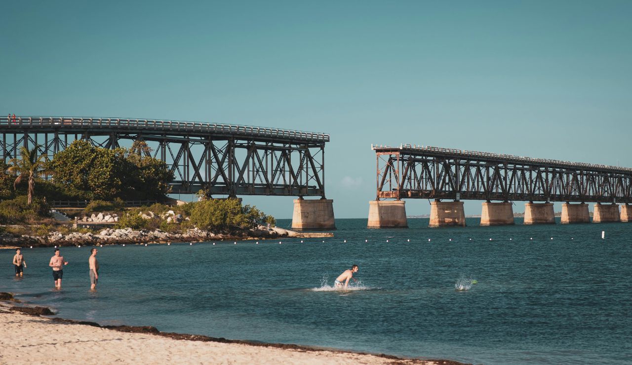Beachgoers relaxing near the historic bridge at Bahia Honda State Park
