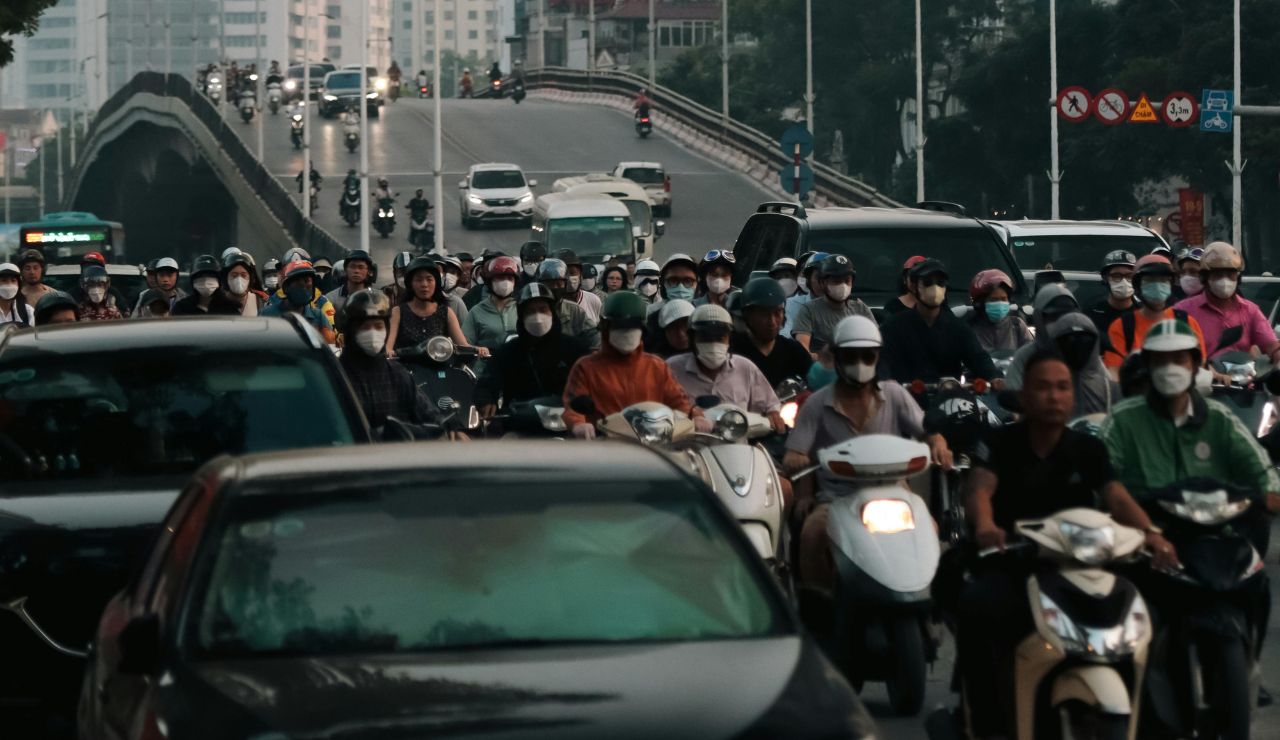 Busy road in Bali filled with scooters and tourists