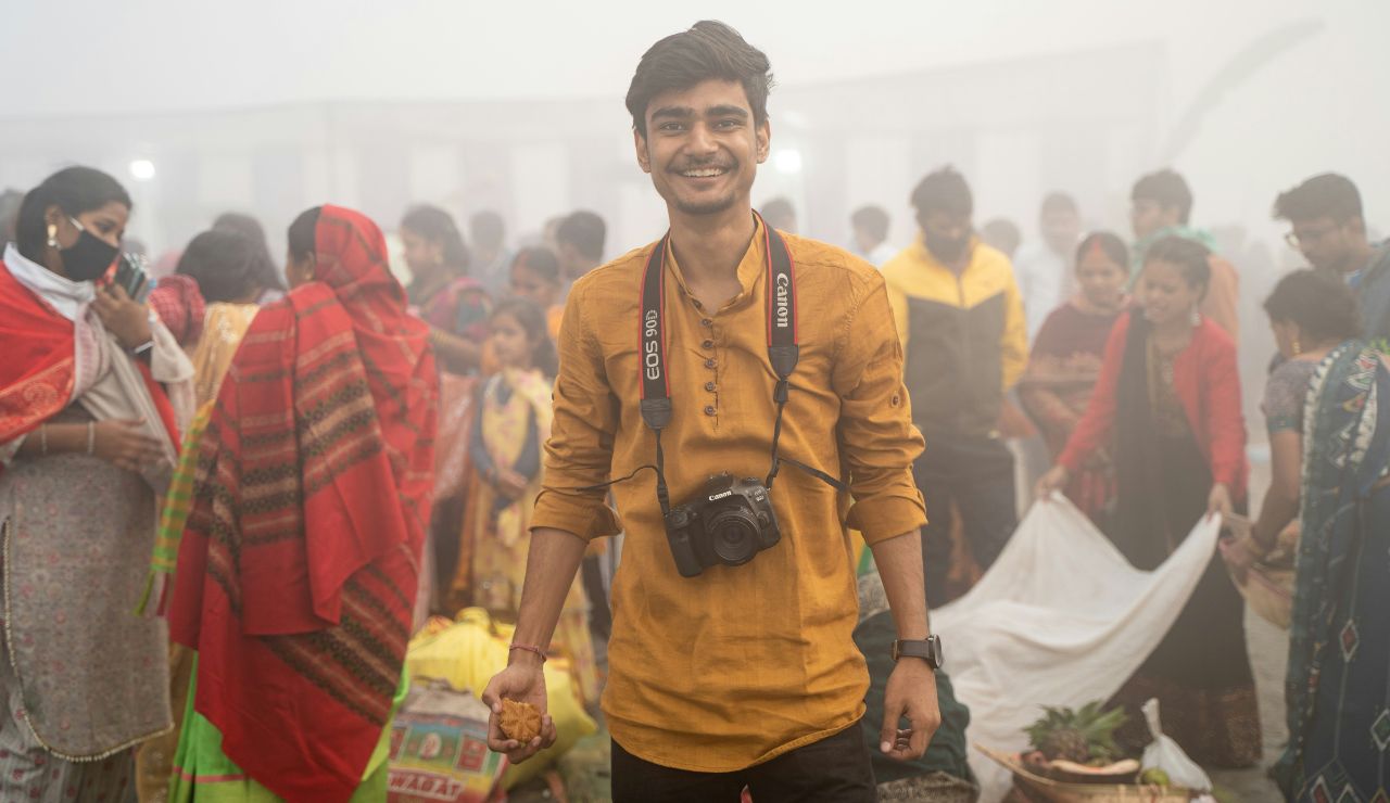 Solo traveler smiling while walking through a local Bangladeshi village