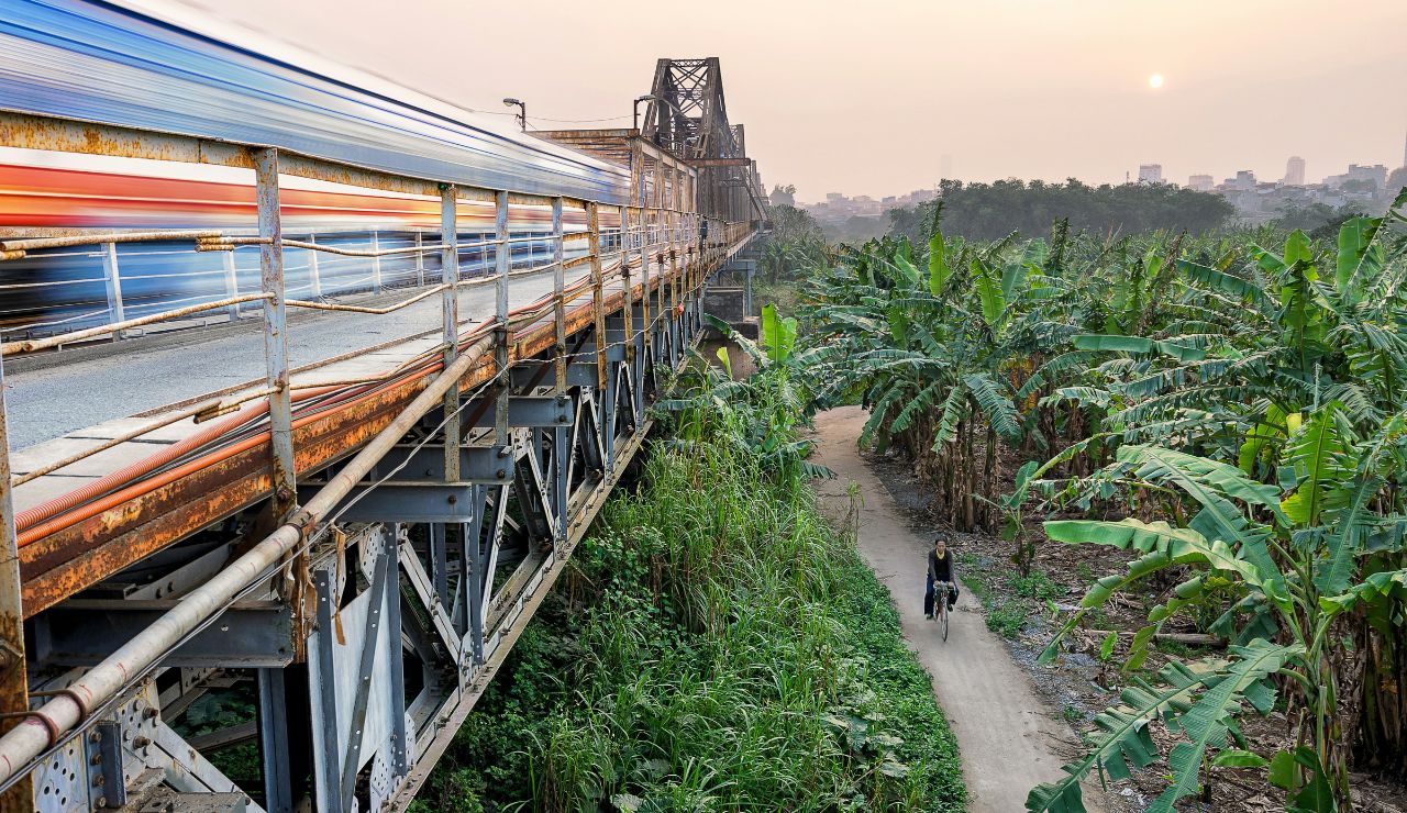 Passenger train passing through green countryside in Bangladesh