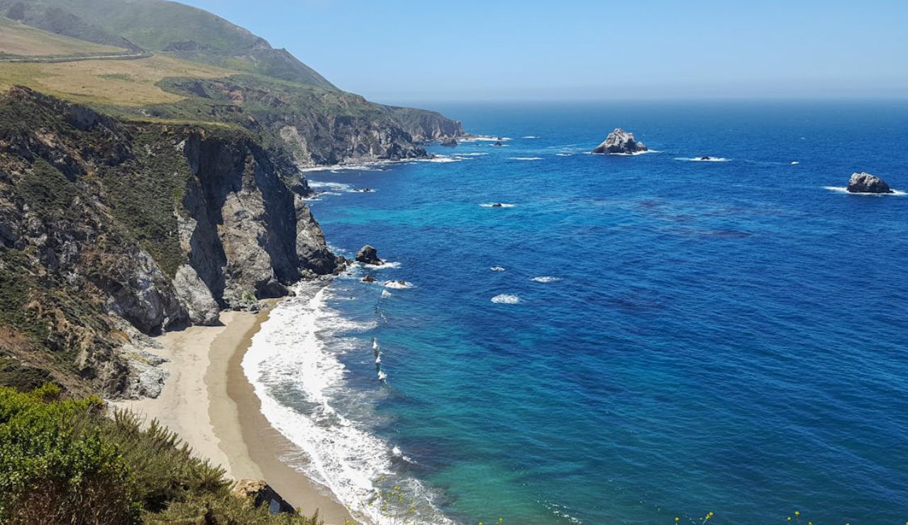 Scenic ocean cliffs and turquoise waters along the Big Sur coast in California.