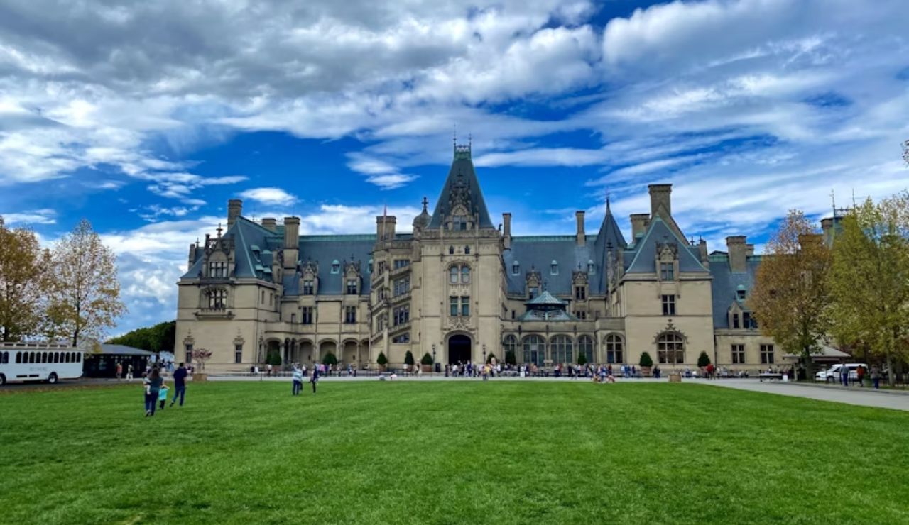 Tourists walking on the lawn in front of the grand Biltmore Estate in Asheville, North Carolina.