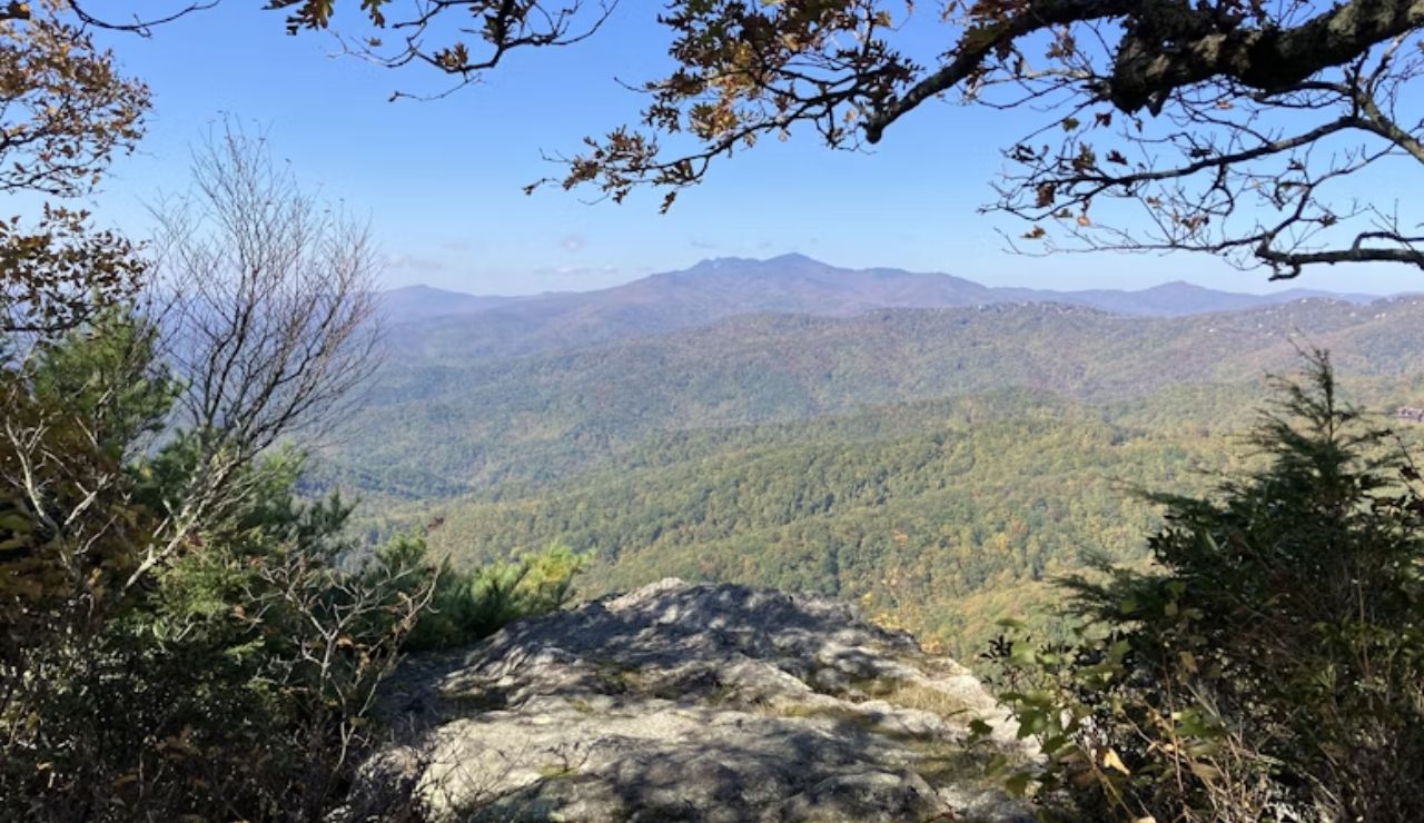 Scenic view of forested mountains from a rocky overlook on the Blue Ridge Parkway in North Carolina.