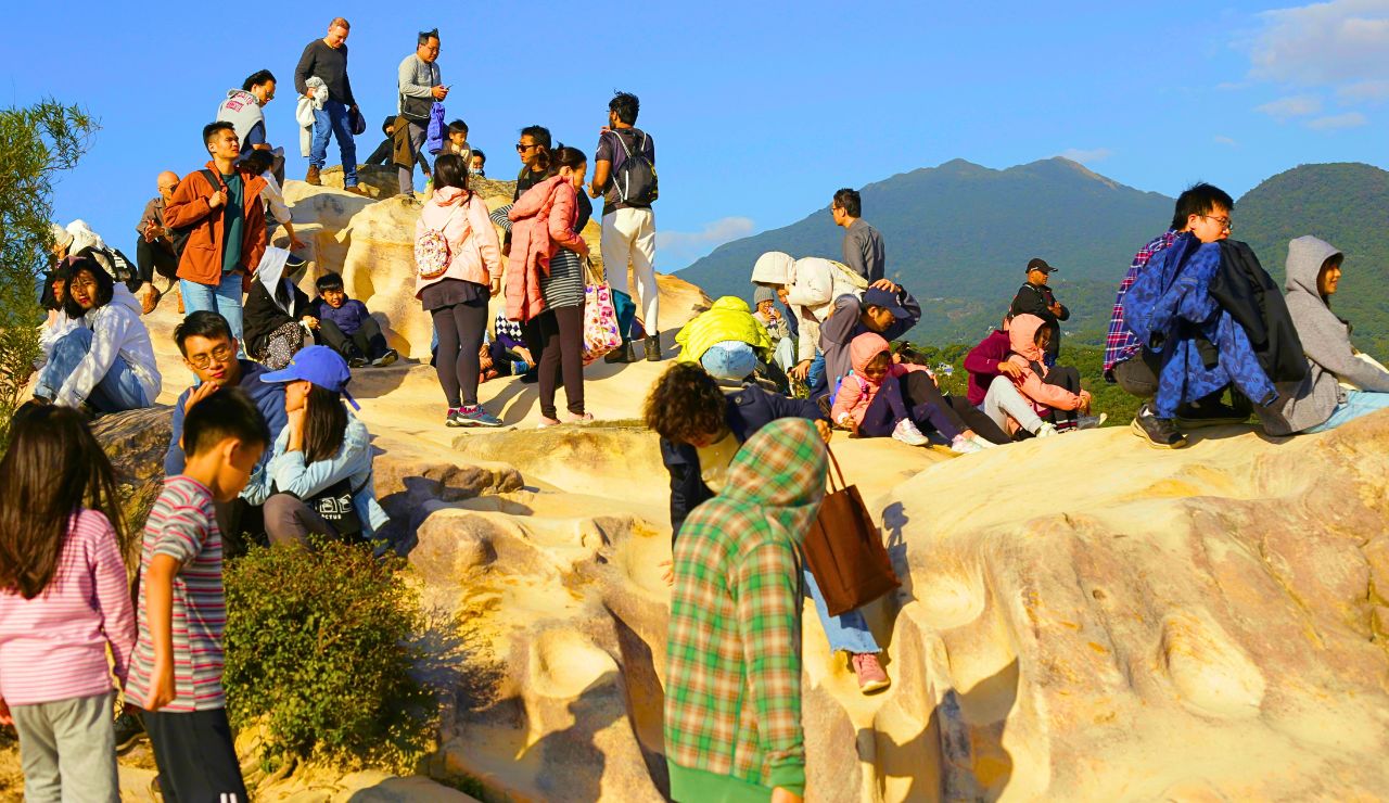 People sliding and playing in large mud pits during South Korea’s Boryeong Mud Festival