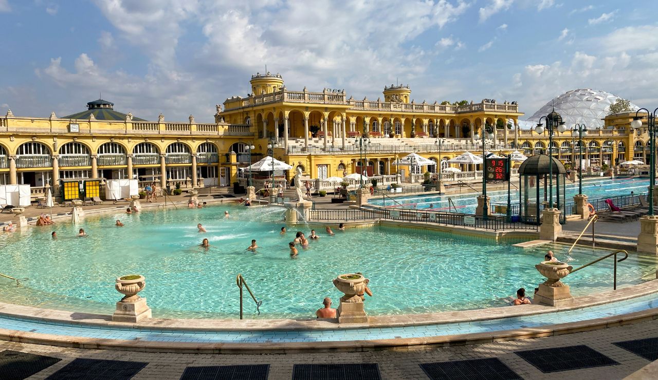  Visitors soaking in Budapest’s historic thermal baths under Art Nouveau arches.