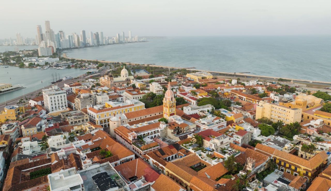 Aerial view of Cartagena, Colombia, showing the historic walled city with colonial architecture and the modern skyline along the Caribbean coast.