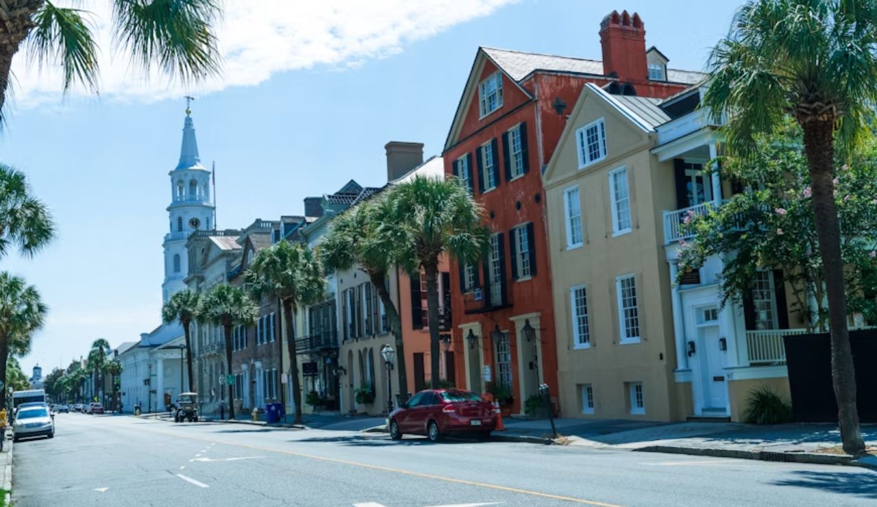 Colorful historic homes and palm trees along a street in Charleston, South Carolina.